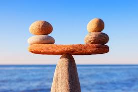 The rock can balance on a single point because the weight on both sides is equal.